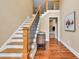 Inviting foyer with wooden staircase, hardwood floors, and decorative wrought iron railings at 3865 Pointer Rd, Loganville, GA 30052