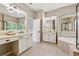 Elegant bathroom with double vanity, soaking tub, and neutral color palette at 4815 Westgate Drive, Cumming, GA 30040