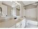Bright bathroom with white cabinets, granite counters, and combination tub/shower at 4815 Westgate Drive, Cumming, GA 30040