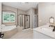 A luxurious bathroom featuring a shower, soaking tub, and ample counter space at 4815 Westgate Drive, Cumming, GA 30040