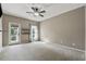 Bedroom with neutral carpet, light-filled windows, and access to a balcony at 4815 Westgate Drive, Cumming, GA 30040