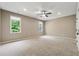 Spacious carpeted bedroom with a ceiling fan and natural light from two windows at 4815 Westgate Drive, Cumming, GA 30040
