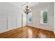 Elegant dining room featuring hardwood floors, a decorative chandelier, and natural light from shuttered windows at 4815 Westgate Drive, Cumming, GA 30040