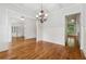 Open dining room showcasing hardwood floors, a chandelier, and an inviting doorway to another room at 4815 Westgate Drive, Cumming, GA 30040