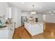 Well-lit kitchen featuring a large island, stainless appliances, and granite countertops at 4815 Westgate Drive, Cumming, GA 30040