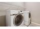 Close-up of modern Samsung washer and dryer set in laundry area with overhead rack at 4815 Westgate Drive, Cumming, GA 30040