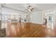 Spacious living area showing an open floor plan to kitchen with hardwood flooring and ample lighting at 4815 Westgate Drive, Cumming, GA 30040