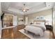Serene main bedroom with a tray ceiling, hardwood floors, and a sitting area at 4815 Westgate Drive, Cumming, GA 30040