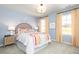 Bright bedroom with colorful decor, two windows, and neutral carpet at 502 Regency Trl, Acworth, GA 30102