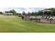 Fenced community playground with slides and play equipment on a well-maintained green lawn at 502 Regency Trl, Acworth, GA 30102