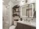 Modern bathroom with glass shower, white subway tile, floating shelves, and lighted medicine cabinet at 504 River Run Dr, Atlanta, GA 30350