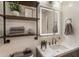 Stylish bathroom with marble countertop, decorative shelves, vanity with an illuminated mirror, and modern fixtures at 504 River Run Dr, Atlanta, GA 30350