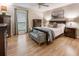 Spacious bedroom with wood flooring, multiple dressers, seating, and large windows for natural light at 504 River Run Dr, Atlanta, GA 30350