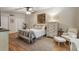 Comfortable bedroom with a four-poster bed, soft rug, ceiling fan and natural light at 504 River Run Dr, Atlanta, GA 30350