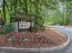 Welcome to River Run: A private community marked by a beautiful sign and colorful flowerbed at 504 River Run Dr, Atlanta, GA 30350