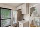 Bright kitchen features stainless steel refrigerator and view of a staircase to upper level at 504 River Run Dr, Atlanta, GA 30350