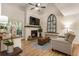 Cozy living room with a fireplace, hardwood floors, vaulted ceiling, and plenty of natural light at 504 River Run Dr, Atlanta, GA 30350