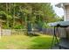 Spacious backyard featuring a trampoline, wooden fence, and lush greenery great for fun at 5251 Centennial Hill Nw Dr, Acworth, GA 30102