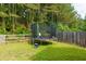 Inviting backyard features a trampoline and wooded backdrop, perfect for entertaining at 5251 Centennial Hill Nw Dr, Acworth, GA 30102