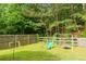 Large backyard with a play set offers space for outdoor activities and leisure at 5251 Centennial Hill Nw Dr, Acworth, GA 30102