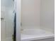 Bright bathroom featuring a glass shower and soaking tub with a white tiled shower at 5251 Centennial Hill Nw Dr, Acworth, GA 30102