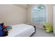 Light bedroom features a vaulted window and plush toys adding cozy charm at 5251 Centennial Hill Nw Dr, Acworth, GA 30102