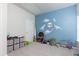 The room features a blue accent wall with dinosaur decor and plush carpeting at 5251 Centennial Hill Nw Dr, Acworth, GA 30102