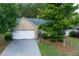 Charming brick home with a well-kept lawn, two-car garage, and beautiful landscaping at 5251 Centennial Hill Nw Dr, Acworth, GA 30102