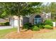 Charming brick home with a well-manicured front lawn, lush landscaping, and a two-car garage at 5251 Centennial Hill Nw Dr, Acworth, GA 30102
