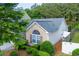Attractive brick home with a well-landscaped front yard, a two-car garage, and modern architectural details at 5251 Centennial Hill Nw Dr, Acworth, GA 30102