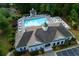 Aerial view of a community pool with lounge chairs and a gazebo surrounded by lush greenery and well-maintained landscaping at 5251 Centennial Hill Nw Dr, Acworth, GA 30102