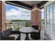 Balcony view with a round table and chairs, brick pillars, and wrought iron railing at 58 Canton St # 410, Alpharetta, GA 30009