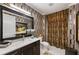 Stylish bathroom with a marble countertop, statement wallpaper, and patterned shower curtain at 58 Canton St # 410, Alpharetta, GA 30009
