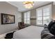 Cozy bedroom with plush rug, unique artwork, and bright natural light from shuttered windows at 58 Canton St # 410, Alpharetta, GA 30009