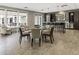 Clubhouse area with seating around a table and a separate high-top table with bar stools at 58 Canton St # 410, Alpharetta, GA 30009