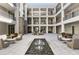 Charming courtyard with seating areas, a decorative water feature, and manicured landscaping at 58 Canton St # 410, Alpharetta, GA 30009