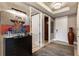 Inviting hallway features a dark wood dresser, modern artwork, and wood-look flooring at 58 Canton St # 410, Alpharetta, GA 30009