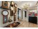 Hallway decorated with unique clocks, a black bench, interesting art, and hardwood floors at 58 Canton St # 410, Alpharetta, GA 30009