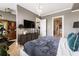 Spacious main bedroom with a wall-mounted tv, neutral paint, and a view to the closet at 58 Canton St # 410, Alpharetta, GA 30009
