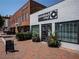 Street view of shops on a brick sidewalk, including Comeback Vinyl with lush planters at 58 Canton St # 410, Alpharetta, GA 30009