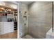Glass enclosed shower and an open closet with custom shelving at 58 Canton St # 410, Alpharetta, GA 30009