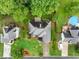 An aerial view of a beautifully landscaped home with a pool, surrounded by lush greenery and neighboring houses at 2910 Waverly Place Dr, Dacula, GA 30019