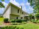 Rear exterior view with a raised deck, a well-kept lawn, and mature landscaping at 2910 Waverly Place Dr, Dacula, GA 30019