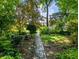 Garden path through lush greenery and verdant foliage leads toward home at 2910 Waverly Place Dr, Dacula, GA 30019