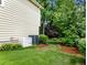 Home exterior featuring a well-maintained yard with an installed backup generator at 2910 Waverly Place Dr, Dacula, GA 30019