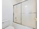 Bathroom featuring a sliding glass shower door and tiled walls at 2910 Waverly Place Dr, Dacula, GA 30019