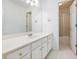 Bright bathroom with white cabinets, a large mirror, and a shower at 2910 Waverly Place Dr, Dacula, GA 30019