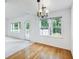 Bright dining room features hardwood floors, white walls, and a stylish chandelier at 2910 Waverly Place Dr, Dacula, GA 30019