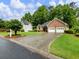 Well-maintained brick home with an attached two-car garage and a spacious driveway at 2910 Waverly Place Dr, Dacula, GA 30019