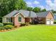 Charming brick home with manicured landscaping and great curb appeal at 2910 Waverly Place Dr, Dacula, GA 30019